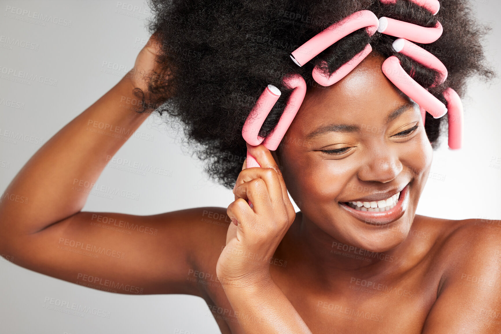 Buy stock photo Happy, afro and black woman with hair curlers, excited for healthy growth for treatment or style. Female person, wellness and volume for texture, cosmetics for natural aesthetic on gray background