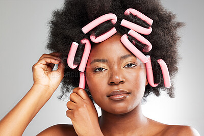 Buy stock photo Black woman, portrait and hair care rollers in studio for afro hairstyle, beauty and natural texture of salon treatment. African, female person and curling tools, aesthetic and white background