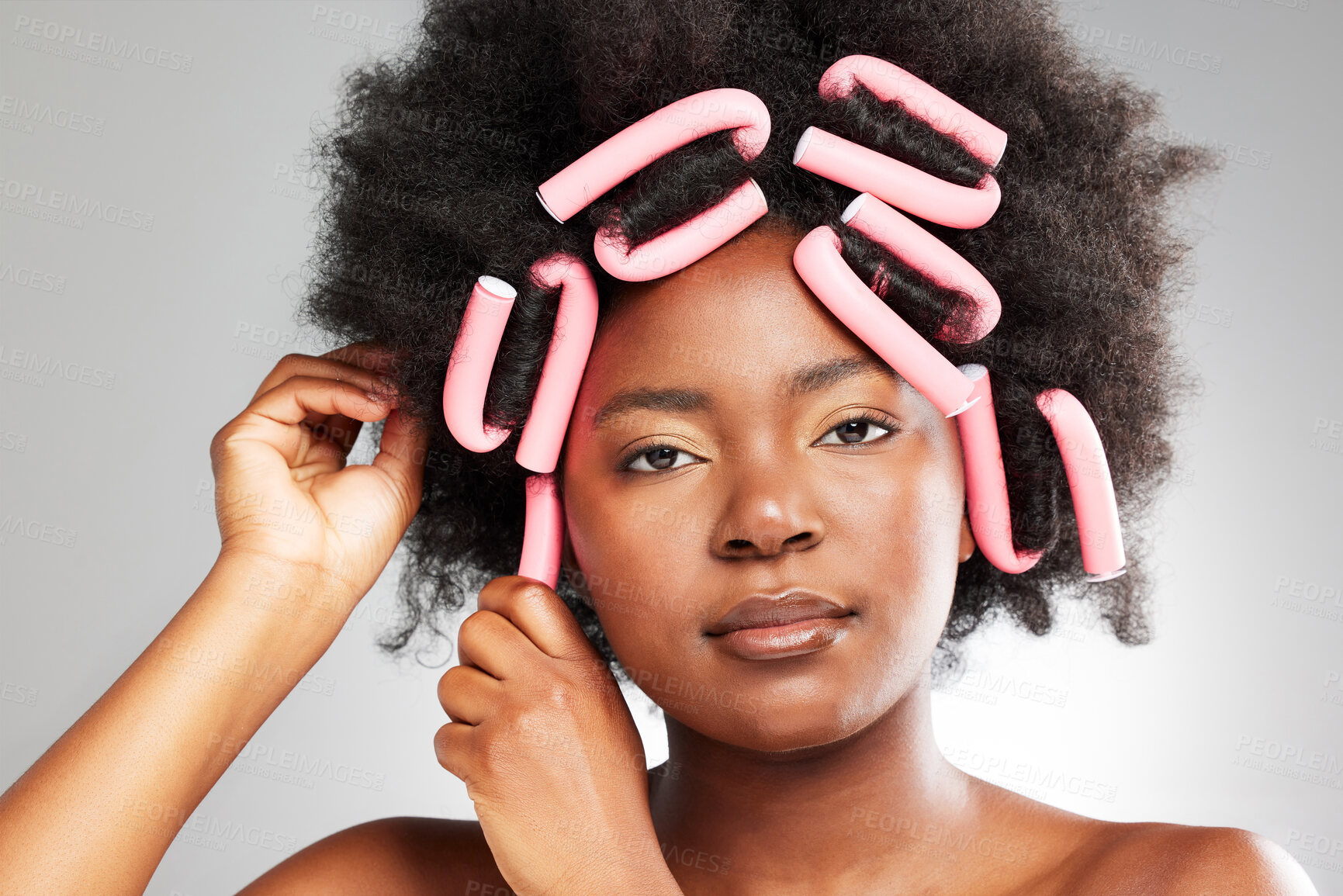 Buy stock photo Black woman, portrait and hair care rollers in studio for afro hairstyle, beauty and natural texture of salon treatment. African, female person and curling tools, aesthetic and white background