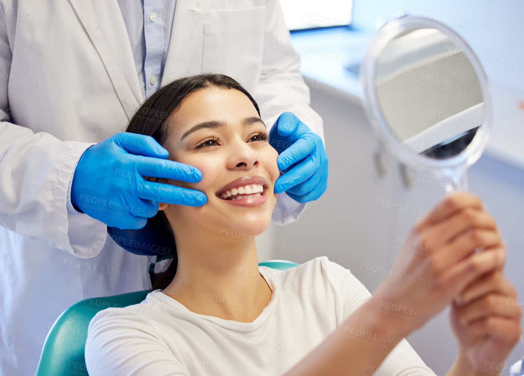 Buy stock photo Shot of a young woman admiring her teeth after having a dental procedure done