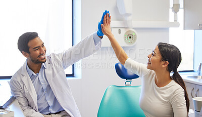 Buy stock photo Shot of a young woman giving her dentist a high five