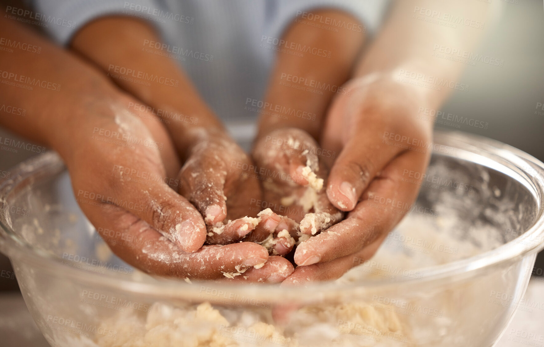 Buy stock photo Cropped shot of an unrecognizable father and son covering their hands in cookie batter while baking together at home