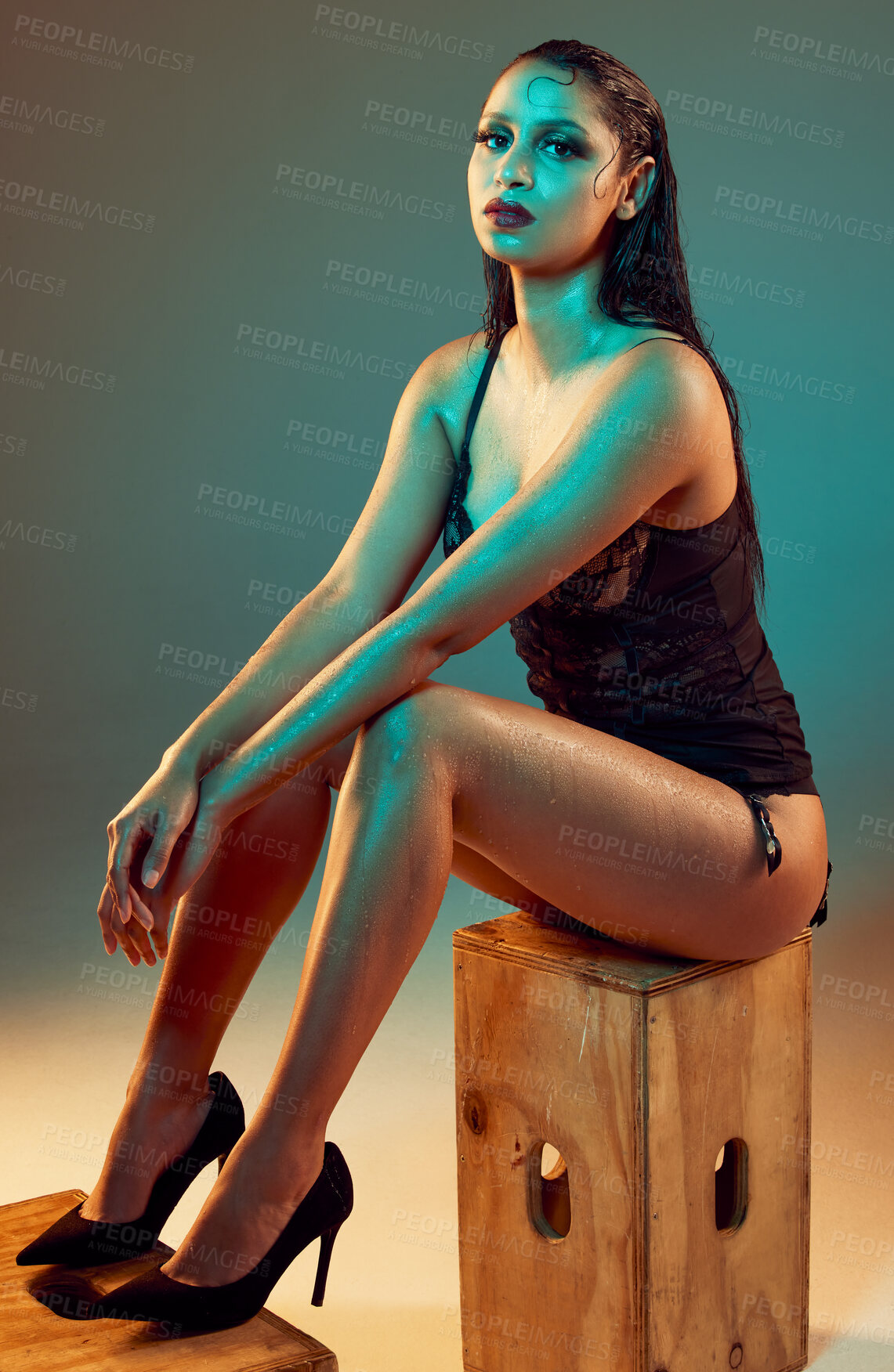 Buy stock photo Portrait, lingerie and woman with body on studio background for confidence, elegant or sensual style. Heels, wet skin and female model sitting on crate for fashion, aesthetic or trendy underwear