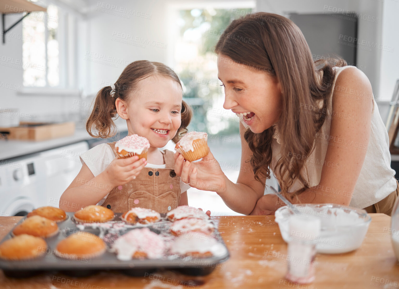 Buy stock photo Shot of a woman baking with her daughter at home