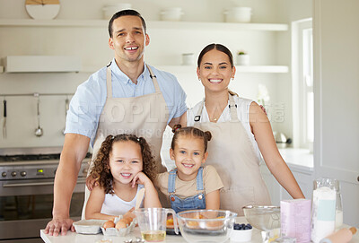 Buy stock photo Shot of a young family baking together at home