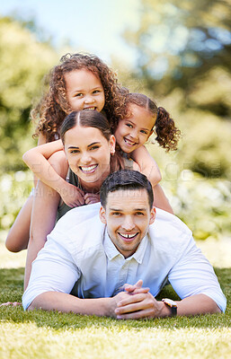 Buy stock photo Portrait of a happy young family enjoying a fun day out at the park