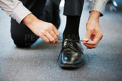 Buy stock photo Businessman, hands and tie shoe in office for preparation, dressing or ready for day. Corporate employee, foot or secure laces in workplace with designer footwear, fashion or professional formal wear