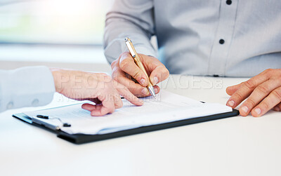 Buy stock photo Closeup shot of two unrecognisable businessmen going through paperwork together in an office