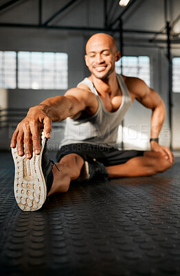 Buy stock photo Balance, man and legs with stretching for exercise, fitness and prevention of muscle tension in gym. Floor, smile and bodybuilder with warm up for wellness, training journey and endurance for workout