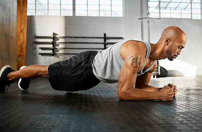 Buy stock photo Shot of a young man completing a plank session