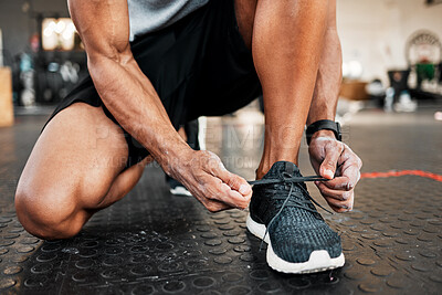 Buy stock photo Hands, shoelace and man in gym, exercise and workout routine with training. Closeup, person and healthy athlete with sneakers, fitness and balance with sports, wellness and challenge