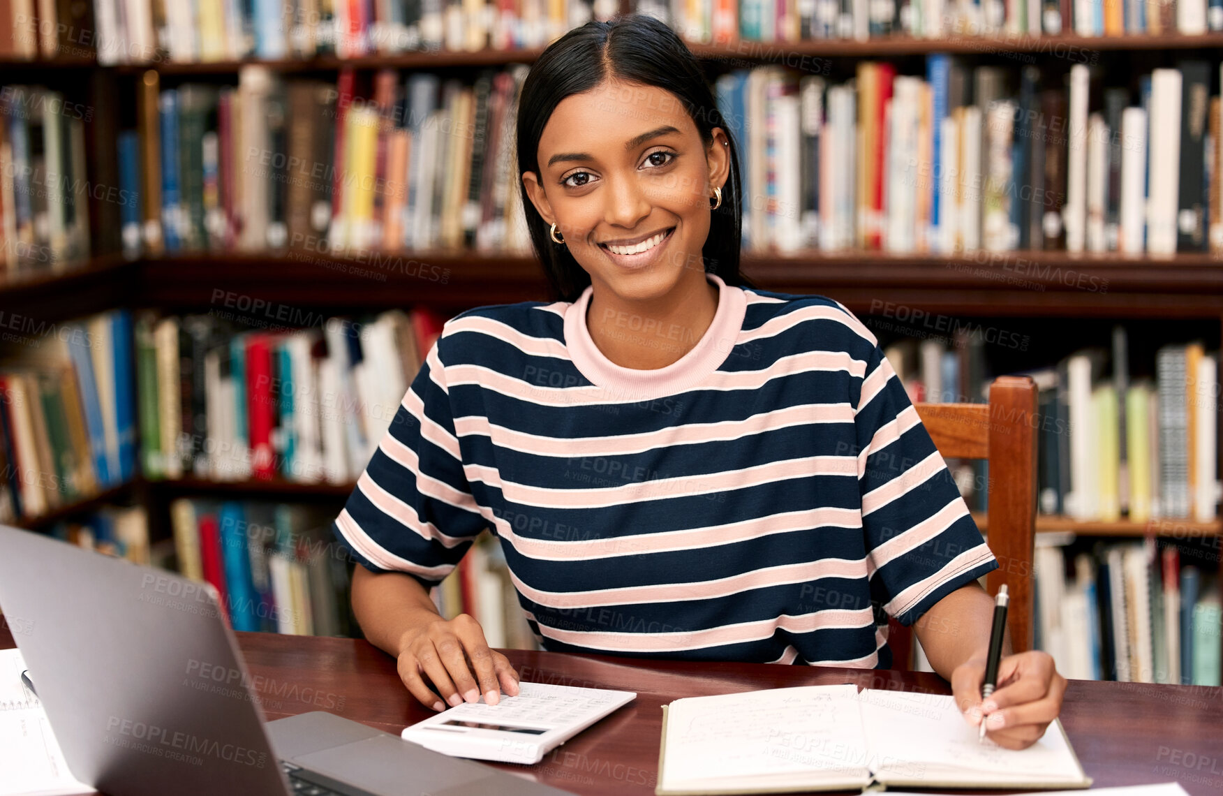 Buy stock photo Portrait, university and woman in library with laptop, notebook and calculator to finance student loan. Smile, notes and girl with research for scholarship budget, study funding or tuition planning.