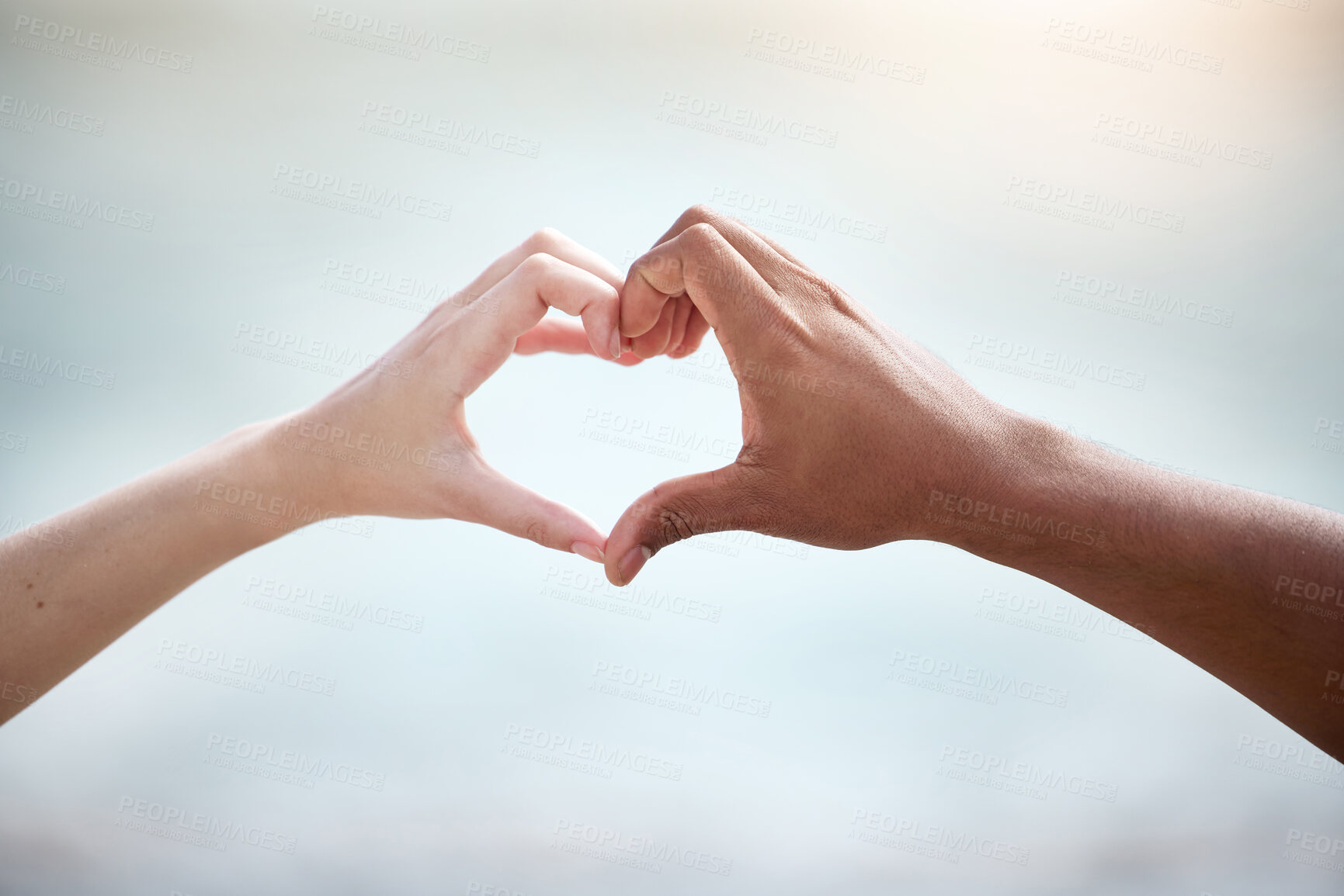 Buy stock photo Interracial couple, beach and love with heart hands for valentines day, support or care together in nature. Closeup of people with emoji for review, feedback or outdoor romance by sea or ocean coast