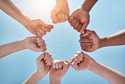 Buy stock photo Team building, fist bump and hands in a circle together for unity, collaboration and connection. Solidarity, diversity and closeup of a group of multiracial people in a round shape by sky background.