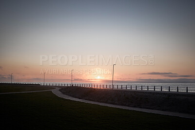 Buy stock photo Beach, path and sunset at promenade outdoor for travel, vacation and sky mockup space on horizon in California. Sea, ocean and nature with grass, lawn and landscape by water for holiday on background