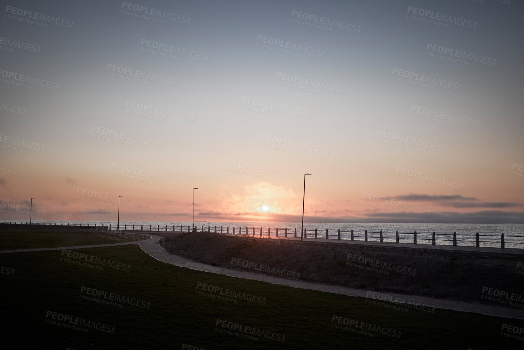 Buy stock photo Beach, path and sunset at promenade outdoor for travel, vacation and sky mockup space on horizon in California. Sea, ocean and nature with grass, lawn and landscape by water for holiday on background