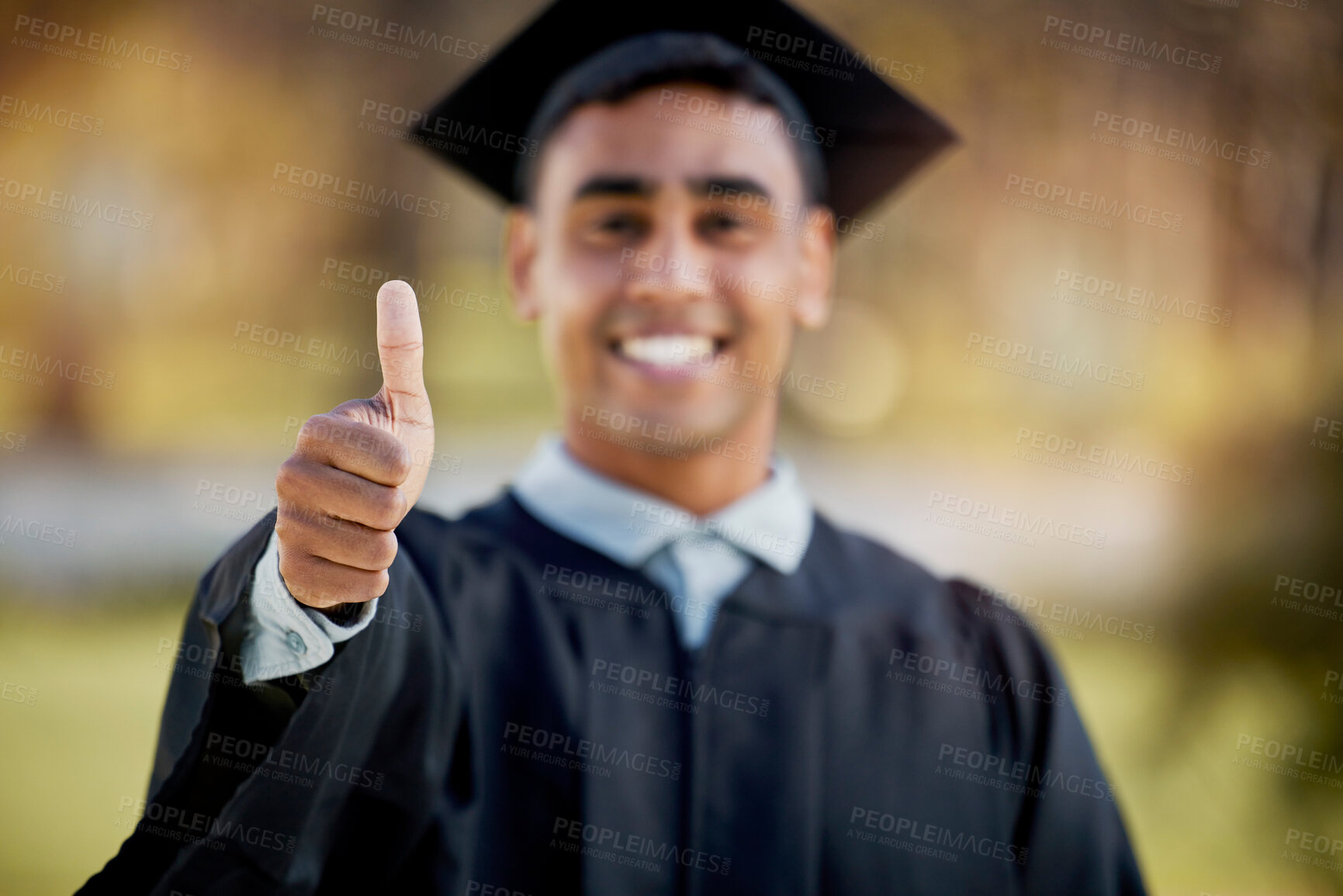 Buy stock photo Portrait of a young man showing thumbs up on graduation day