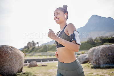 Buy stock photo Shot of a fit young woman going for a run in a park