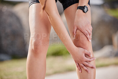 Buy stock photo Shot of an unrecognisable woman experiencing knee pain while working out in nature