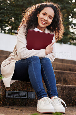 Buy stock photo Portrait of an attractive young female university student sitting outside on campus during her break