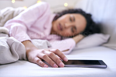 Buy stock photo Sleep, woman and bedroom with hand on phone to snooze alarm, alert and notification for tired, relax and dream. Fatigue, young female and exhausted from insomnia with mobile for time in morning