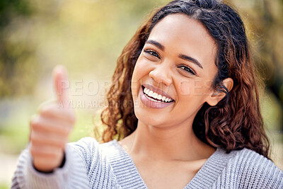 Buy stock photo Cropped portrait of an attractive young female student giving tumbs up to the camera while standing outside on campus