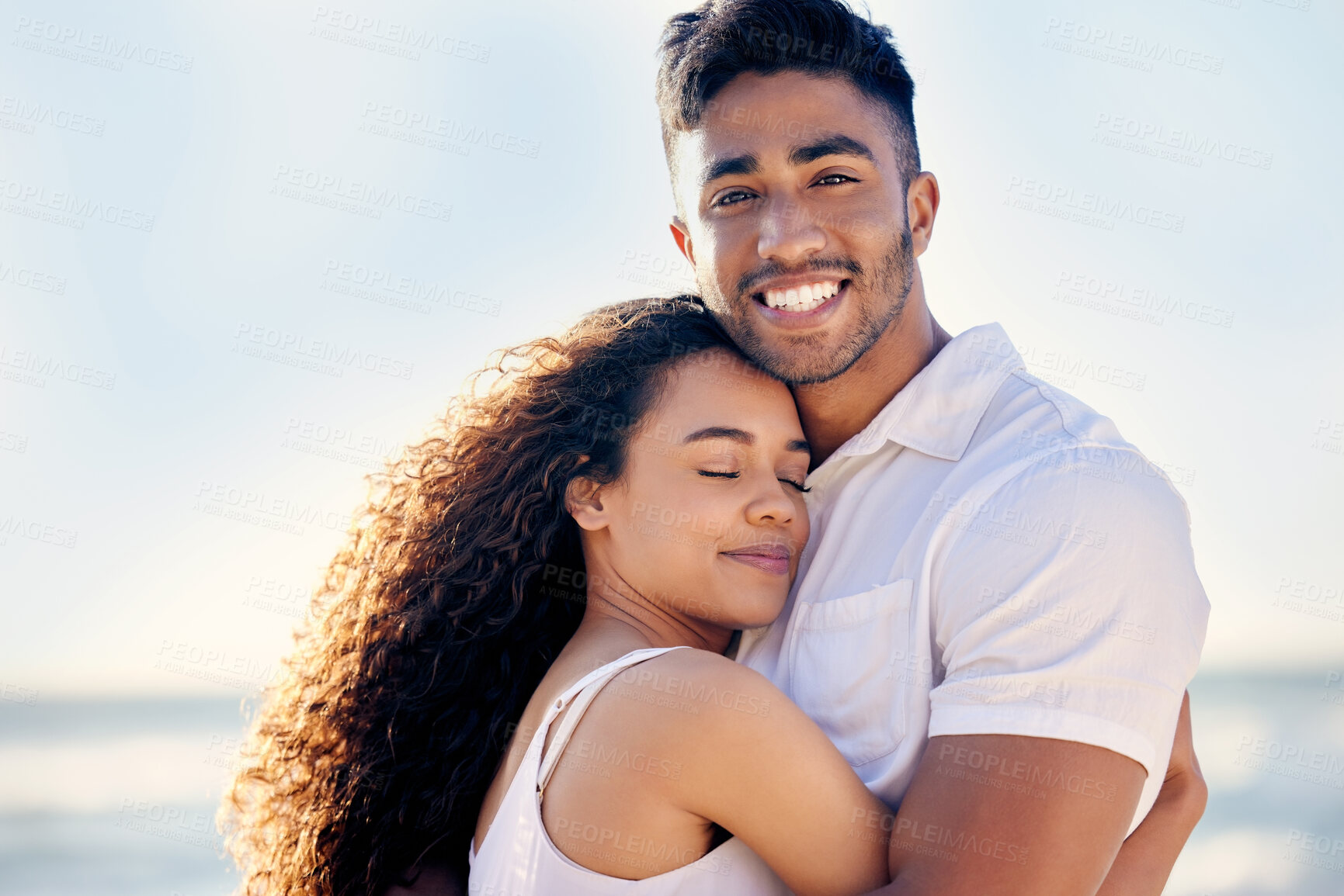 Buy stock photo Love, couple and hug on beach with smile, anniversary and trust by ocean for holiday in Bali. Smiling man, woman and security on seaside with care for romance, relaxing and adventure on island