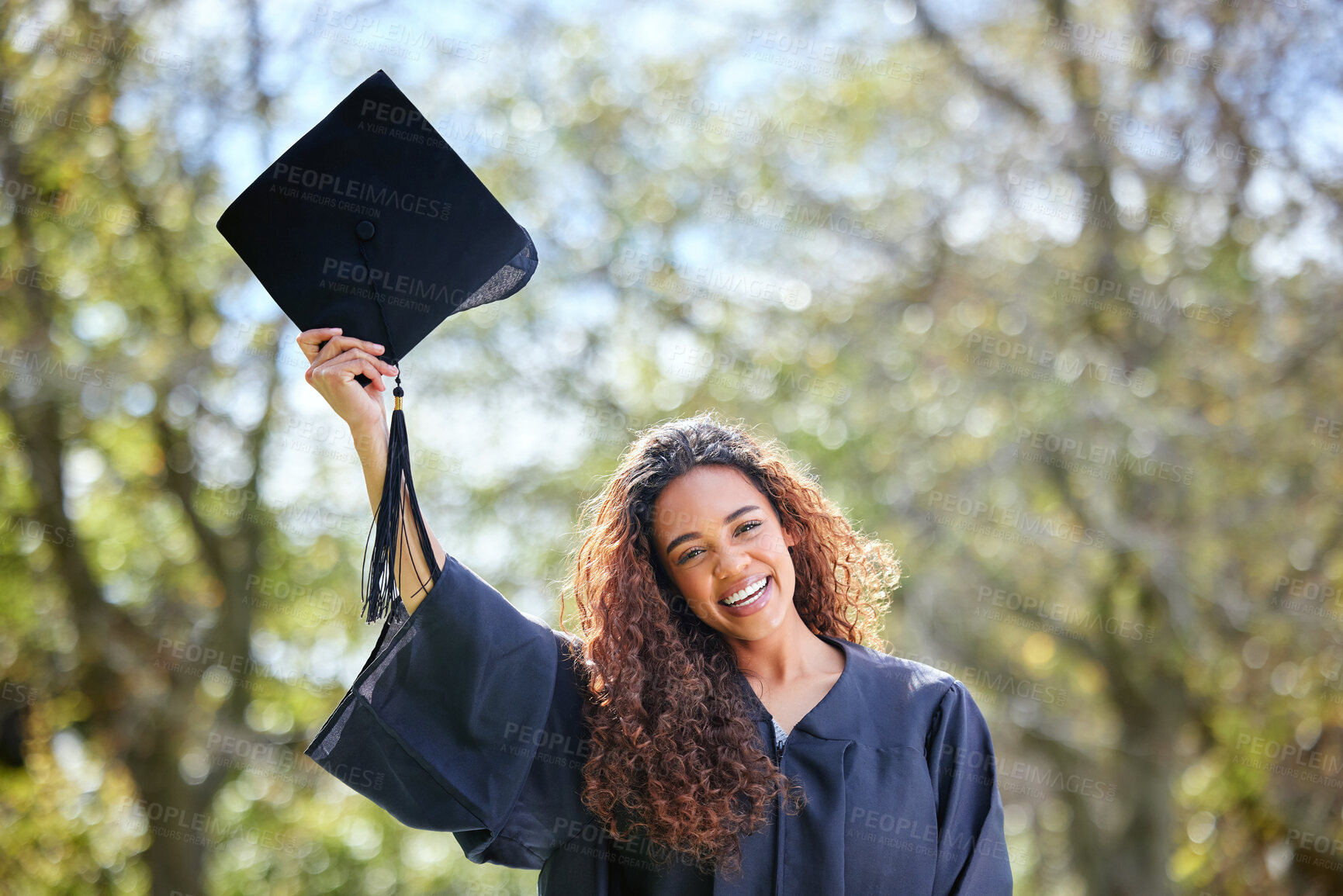 Buy stock photo Celebration, happy and portrait of a woman at her graduation standing outdoor at university. Happiness, smile and female student with graduate cap for success and college degree achievement on campus