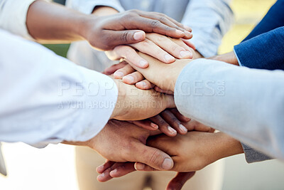 Buy stock photo Shot of a group of unrecognizable businesspeople stacking their hands together outside