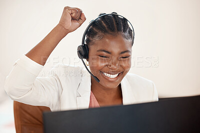 Buy stock photo Shot of a young call centre agent cheering while working on a computer in an office