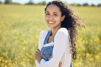 Buy stock photo Portrait, happy and woman with arms crossed in field of flowers for adventure and travel in countryside. Smile, female person and environment for sustainability, ecology and holiday in nature 