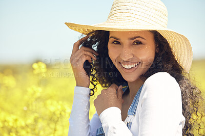 Buy stock photo Farmer, portrait and smile with field, nature and flowers with sun hat for sustainable farming. Woman, agriculture and ecology with meadow, environment or ecology for carbon capture or green love