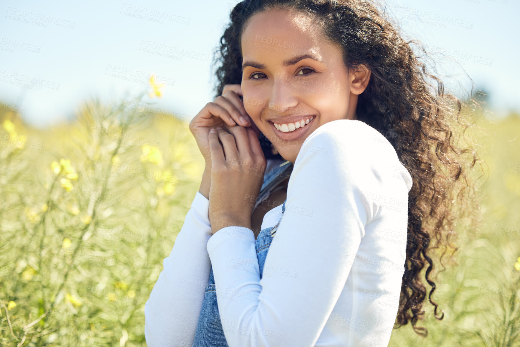 Buy stock photo Portrait, woman and happy in countryside with flowers for adventure, travel and field in nature. Gen z, female person and environment for sustainability, ecology and sunshine in nature with smile