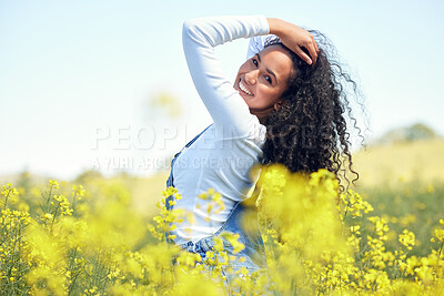 Buy stock photo Woman, portrait and smile in nature with flowers for adventure, travel and holiday in countryside. Gen z, female person and environment for sustainability, happiness and sunshine in field for spring