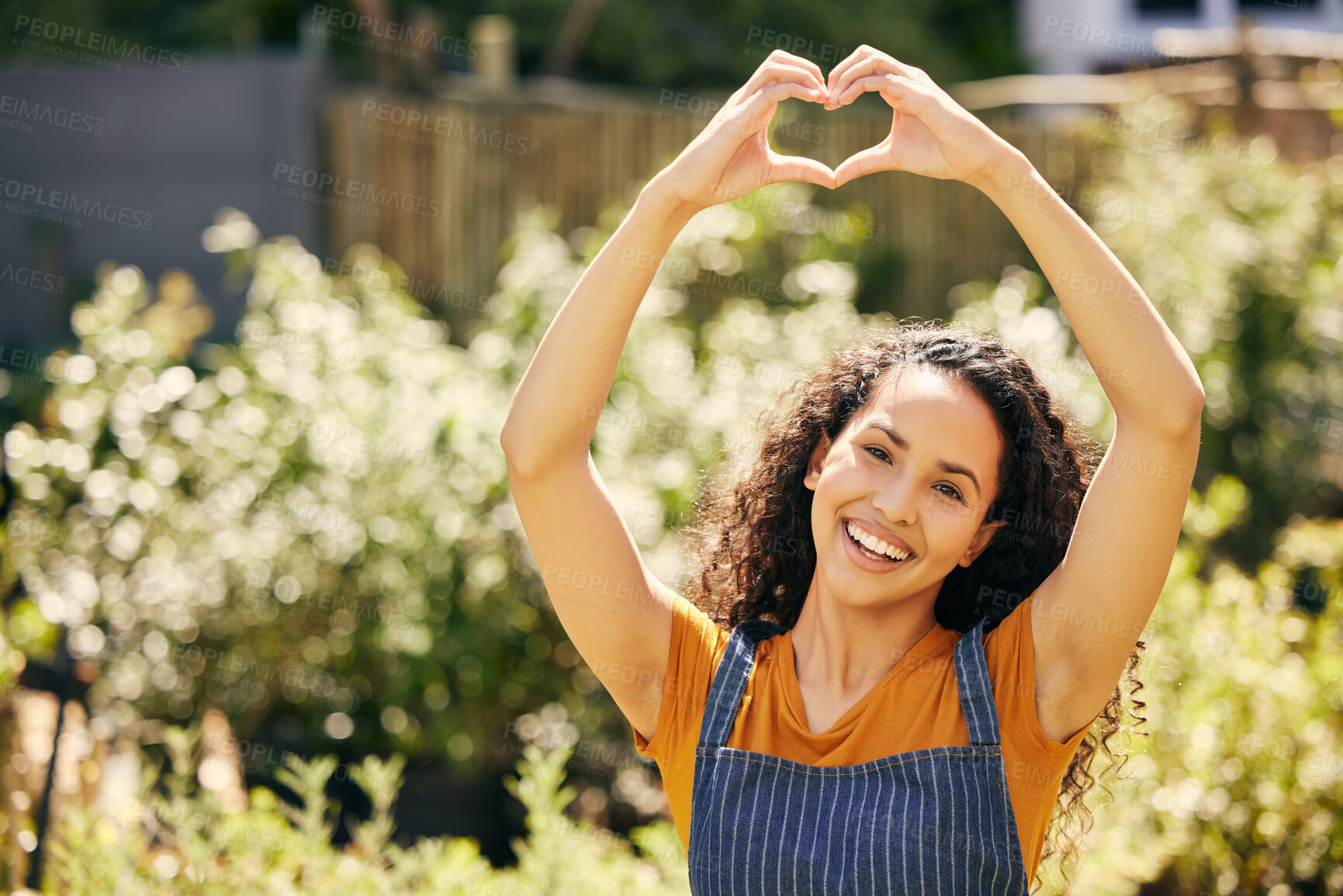 Buy stock photo Happy woman, portrait and small business with heart hands in nature for garden review, vote or love. Young female person or entrepreneur with apron, smile or emoji for eco friendly environment