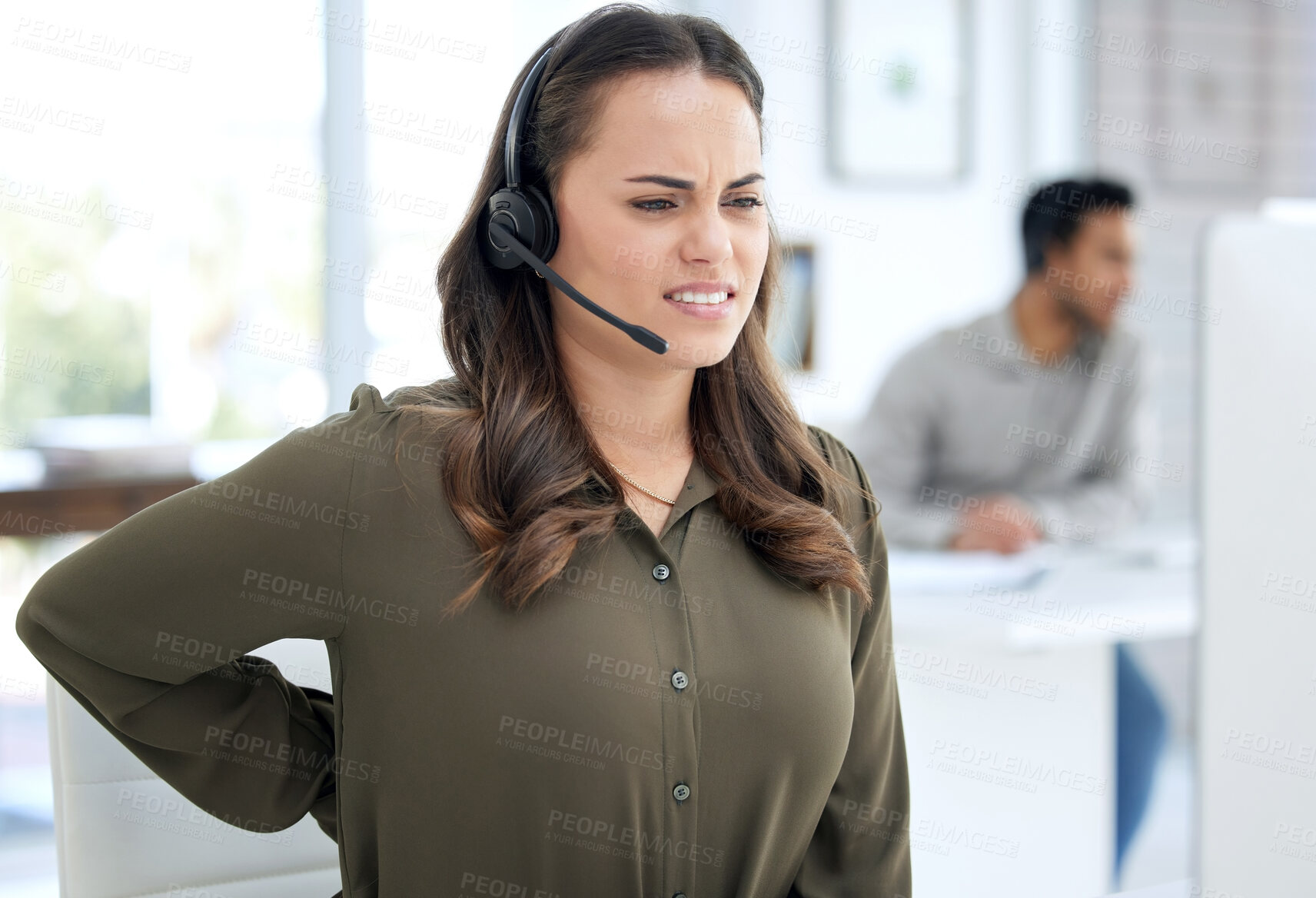 Buy stock photo Call center, back pain and woman, agent or consultant on computer for burnout, health problem and stress. Telecom, customer support and agency worker or young person, spine or muscle injury at desk