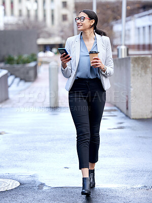 Buy stock photo Shot of a young businesswoman making her way to work