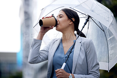 Buy stock photo Business woman is drinking coffee, umbrella and travel with commute to work and person in the city. Young female professional in the rain, enjoying hot drink with traveling, urban and insurance