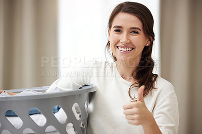 Buy stock photo Shot of a young woman doing laundry at home