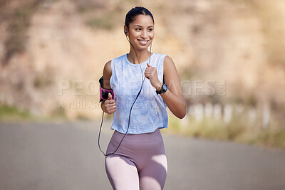 Buy stock photo Cropped shot of an attractive young female athlete enjoying a run outdoors