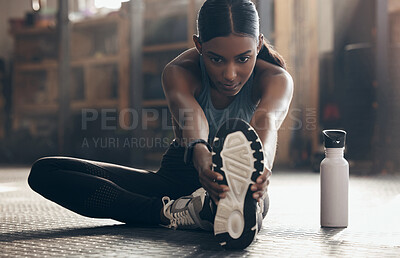 Buy stock photo Woman is stretching legs in gym, fitness and start workout with focus, sneakers and sport preparation. Health, active with serious Indian female warm up and ready for  exercise with determination