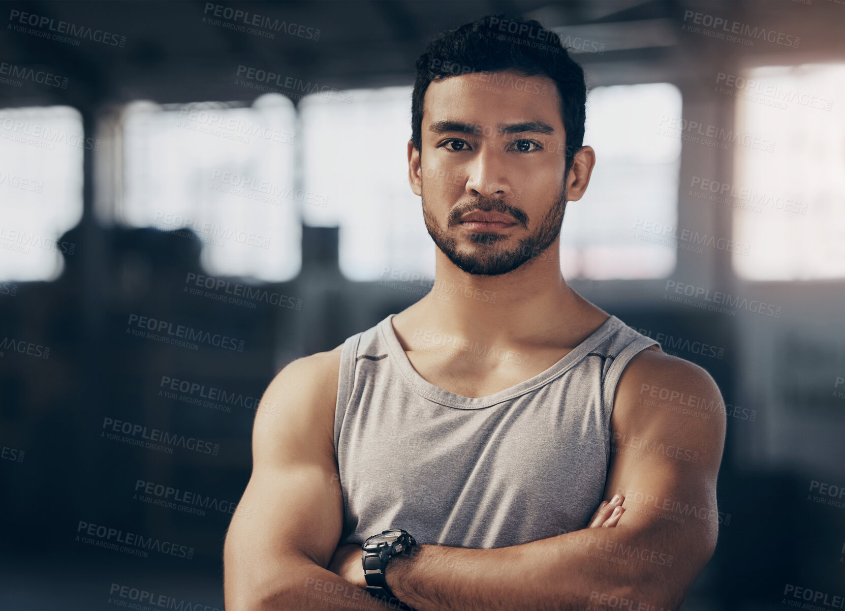 Buy stock photo Fitness, crossed arms and portrait of a personal trainer in the gym before a workout consultation. Confidence, serious and male athlete with a strength arm exercise for biceps in a sports center.