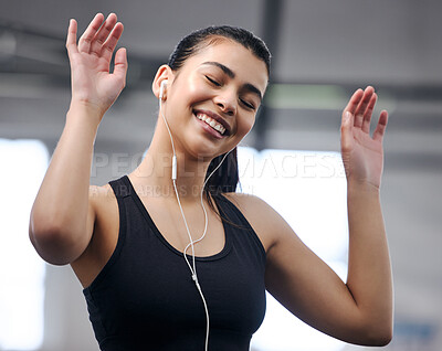 Buy stock photo Girl, earphones and energy at gym for fitness, music and motivation for workout or exercise. Female person, athlete listening and audio for cardio, sports and wellness podcast for training at club