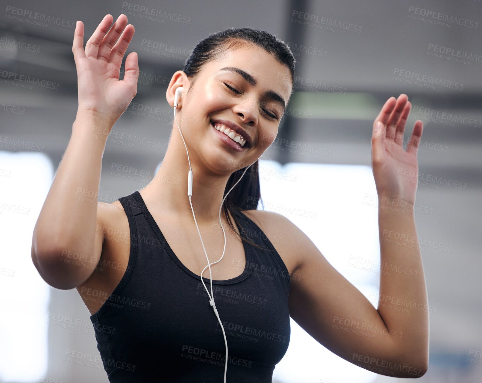 Buy stock photo Girl, earphones and energy at gym for fitness, music and motivation for workout or exercise. Female person, athlete listening and audio for cardio, sports and wellness podcast for training at club