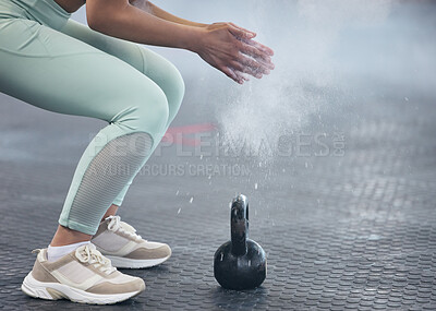 Buy stock photo Shot of an unrecognisable woman dusting her hands with chalk powder before working out with kettle bell weights in a gym