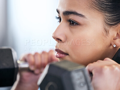 Buy stock photo Woman, fitness and dumbbell in gym for action, exercise and training for strong arm muscle. Person, bodybuilder and athlete for sport and power, serious and equipment for workout or weightlifting