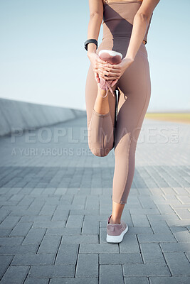 Buy stock photo Rearview shot of an unrecognisable woman stretching her legs while exercising outdoors