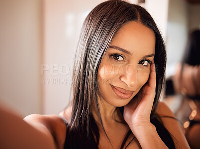 Buy stock photo Cropped shot of a beautiful young woman taking a selfie at home