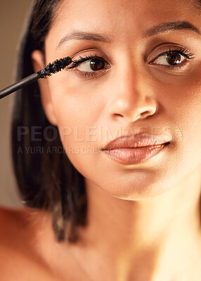 Buy stock photo Shot of a beautiful young woman applying mascara