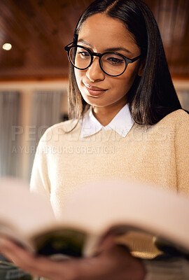 Buy stock photo University student, studying and girl with textbook in home for college, research or school education. Learning course, glasses and Indian woman reading novel for academic information or knowledge